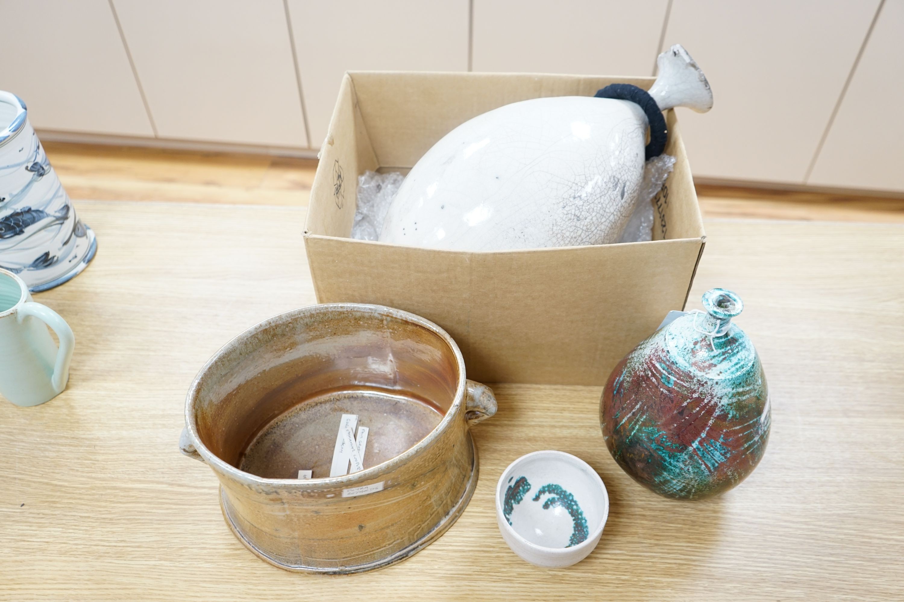 Studio pottery- an Allison Weightman raku fired large albastron form vase, ovoid vase and cup and a Petra Reynolds oval stoneware pot (4) Tallest 44cm